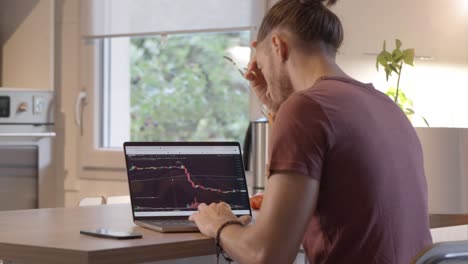 financial downturn: analyzing stock and cryptocurrency losses on a laptop