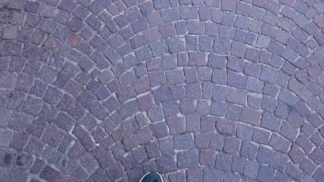 footsteps on cobblestone street in naples, italy