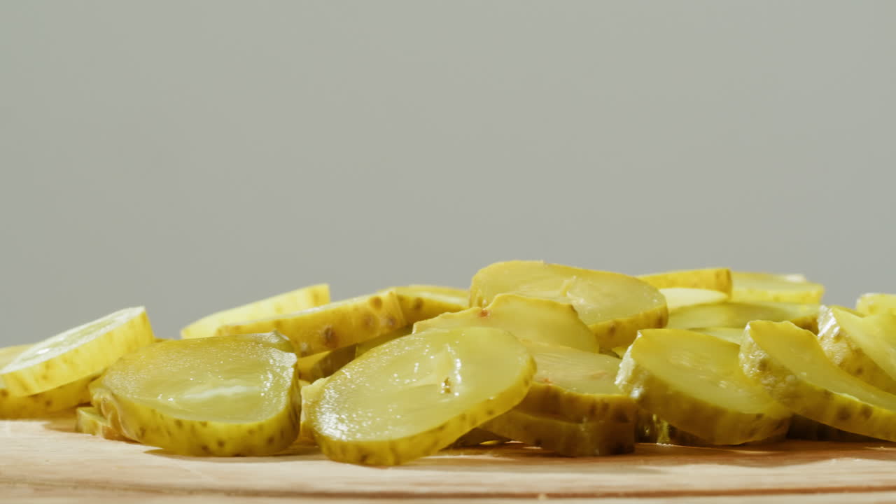 Sliced Dill Pickles on a Wooden Board