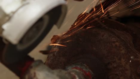 close up, sparks from portable grinding machine, metal pipe cutting, bright sparks
