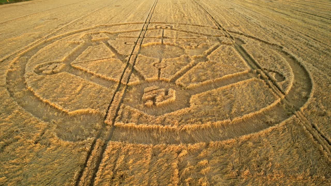 Crop circle Fortnite molecular geometry pattern aerial view on Wiltshire sunset wheat field countryside slow low push in