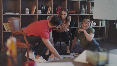 creative businesspeople working with company strategy documents on office floor