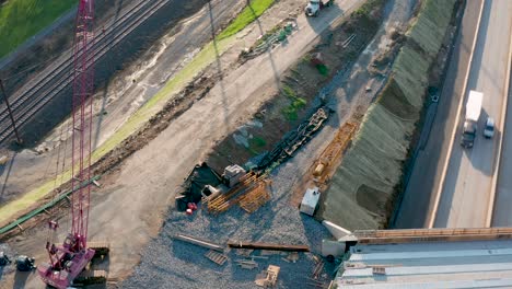 Aerial-tilt-up-reveals-highway-exit,-entrance-ramp-and-bridge-being-replaced