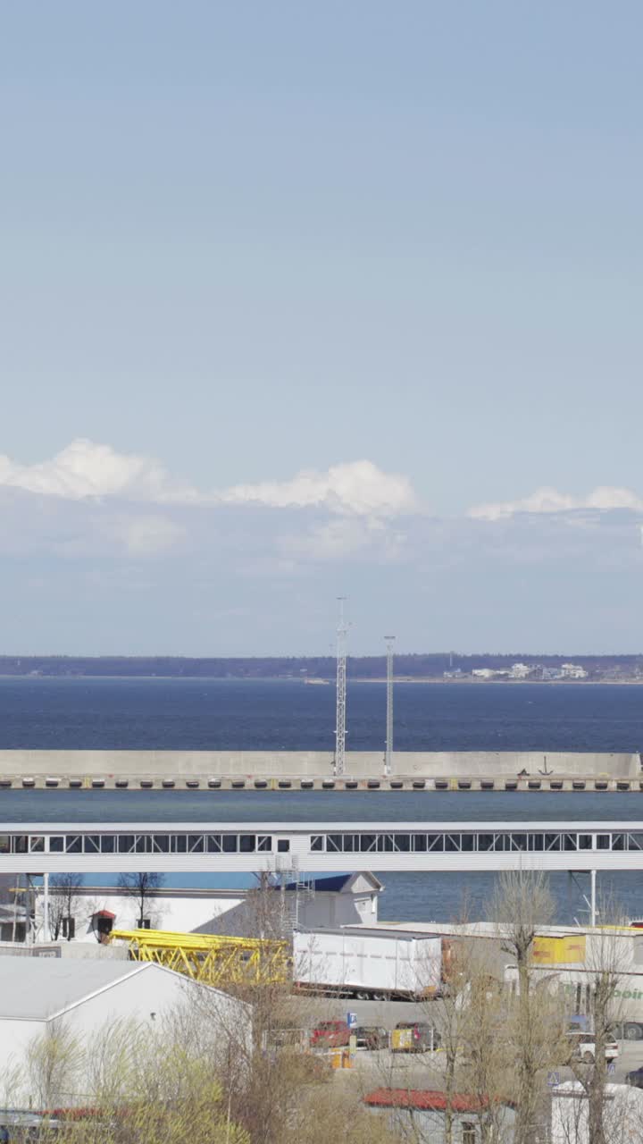 Coastal cityscape with sea, pier, and buildings