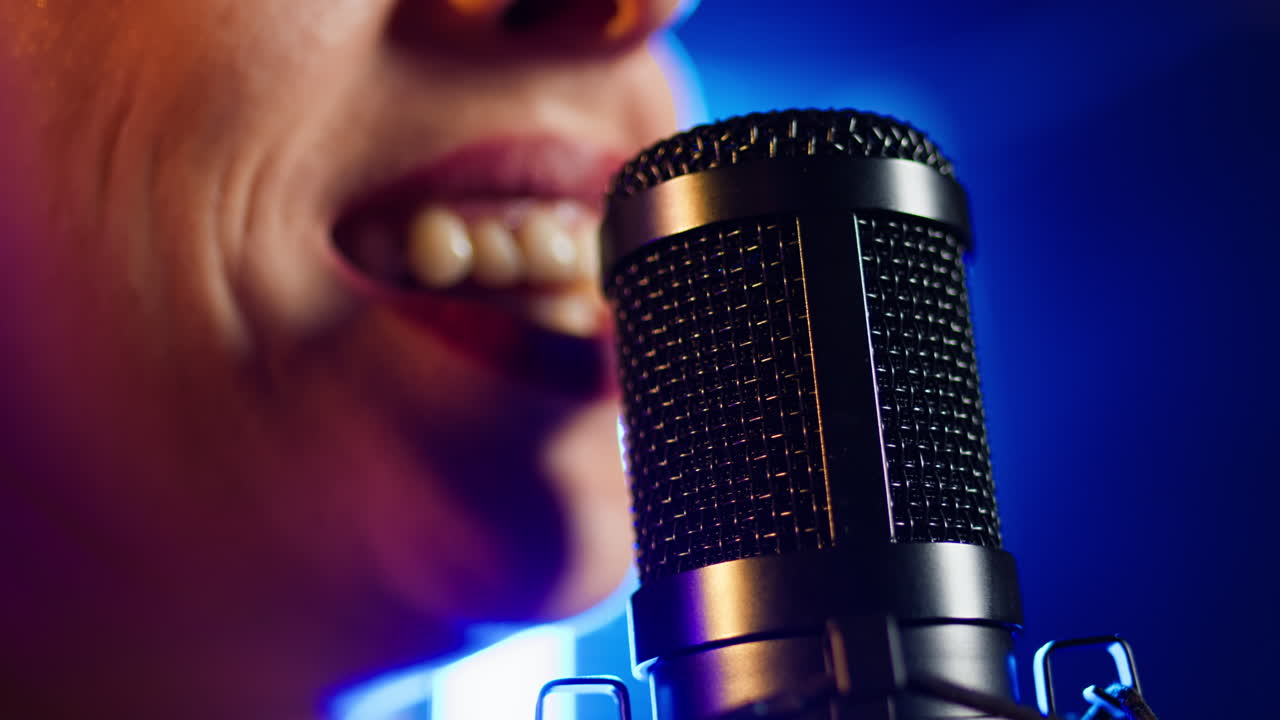 Close-up of a person singing into a microphone