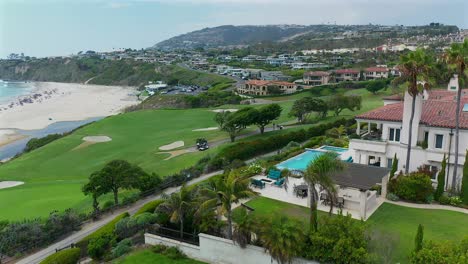 rotating aerial view of a house with a pool overlooking monarch beach golf course in dana point california