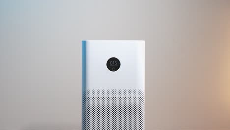 close-up of an air purifier with a display showing good air quality