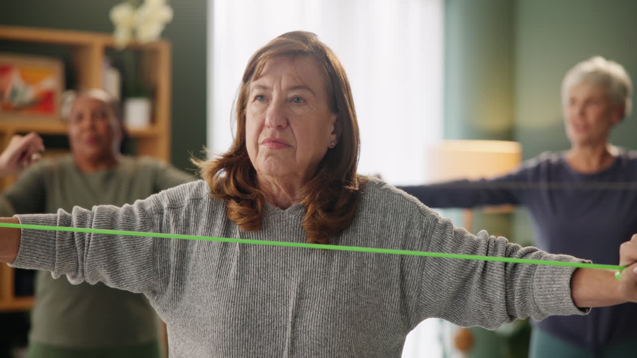 Senior women exercising with resistance bands in a group fitness class