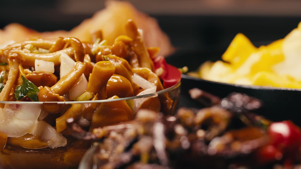 Close-up of fermented yellow honeydew mushrooms with onion in plate. Preservation of vegetables in glass jars. Fermentation preserved mushroom with spices.