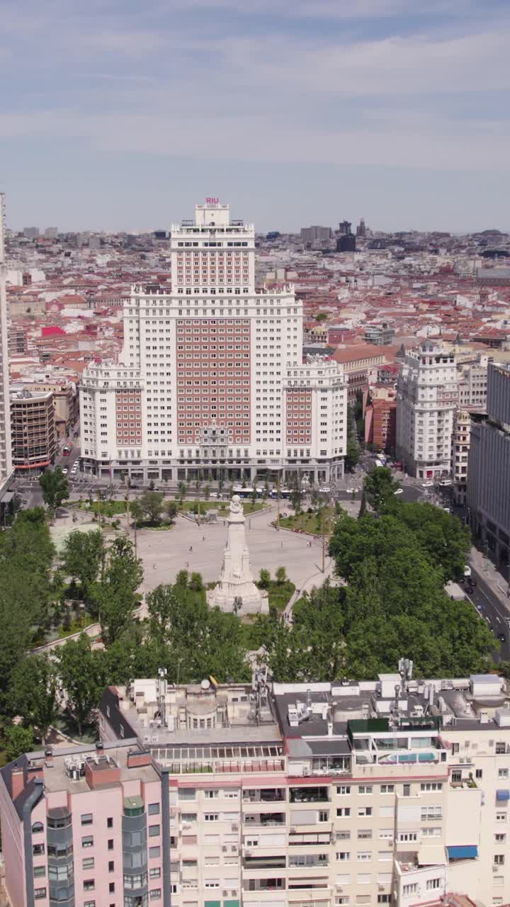 Orbita aerea verticale che riprende Plaza de España nel centro di Madrid con il paesaggio urbano circostante.