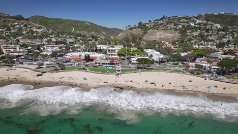 Flying-away-from-Main-beach-in-Laguna-California-with-views-of-the-lifeguard-tower