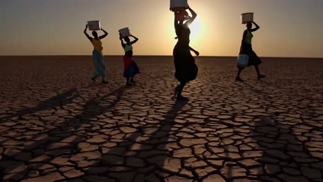 women carrying water in a dry land