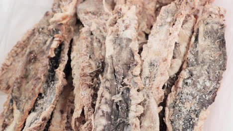 pack of dried fish on a white container