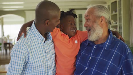 portrait of a senior african american man, his son and grandson.