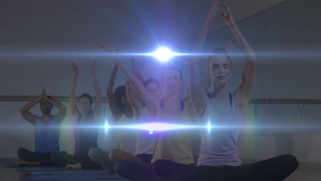 Animation-of-glowing-light-over-people-practicing-yoga