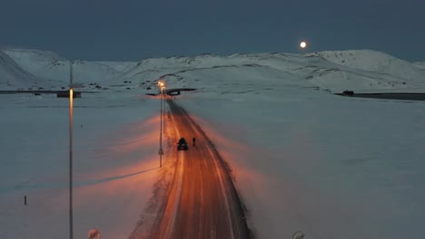 A-car-with-warnings-lights-on,-waiting-at-the-entrance-of-a-tunnel-at-the-Nordkapp,-Norway