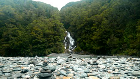 a picturesque waterfall framed by unique rock stacks, creating a harmonious blend of natural beauty and serene landscapes