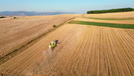 Agriculture hay mower tractor tedder modern field work rural village, aerial drone fieldwork labour
