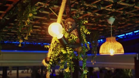 Monkey-statue,-holding-rope-in-hand-and-light