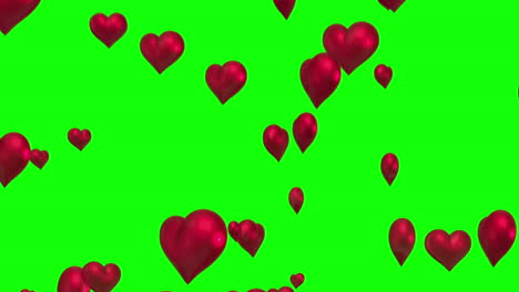 corazones rojos flotando contra la pantalla verde