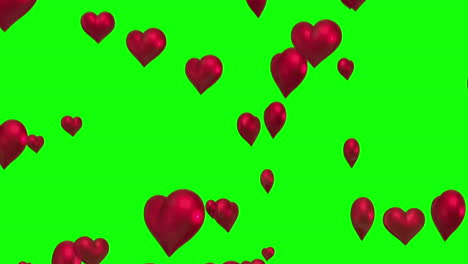 red hearts floating against green screen