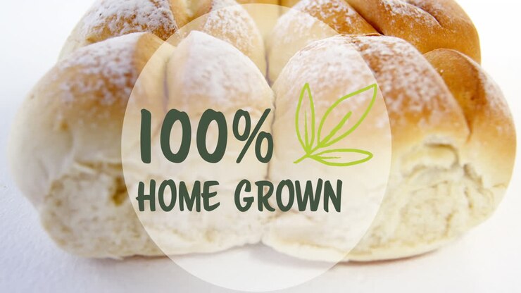 Animation of 100 percent home grown text banner against close up of fresh bread on white background