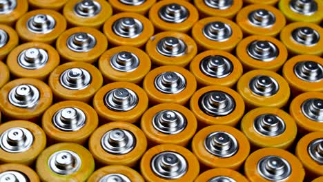 many used aa alkaline batteries, finger batteries in heap ready for recycling. harmful effects of planet earth.