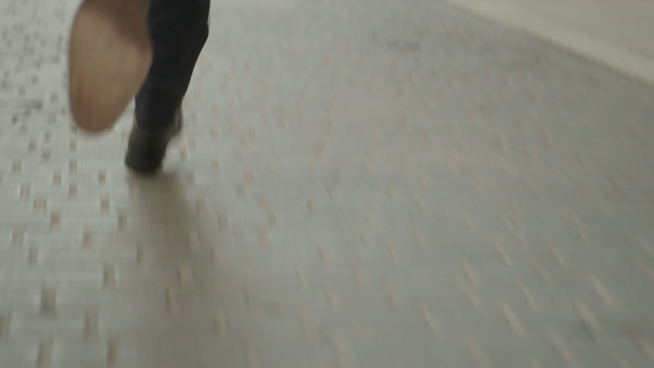 Person Running on Cobblestone Street