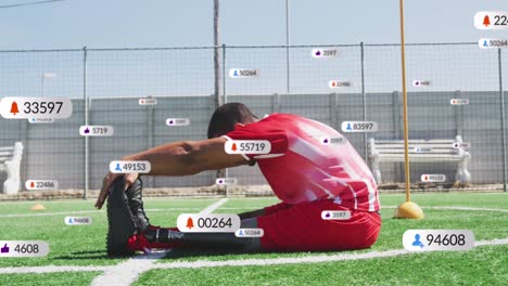 animation of multiple notification bars over biracial soccer player doing stretching on ground