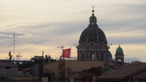 building rooftops and dome of san carlo al corso, rome, italy