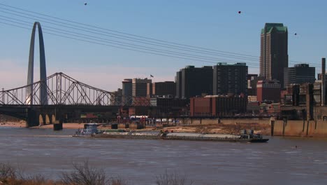 a barge travels on the mississippi river near st louis