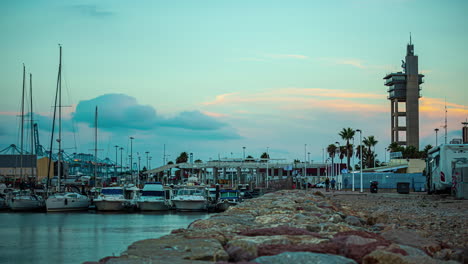 A-Time-Lapse-Shot-Of-The-Sunset-At-The-Rocky-Harbor-With-Boats-And-Buildings