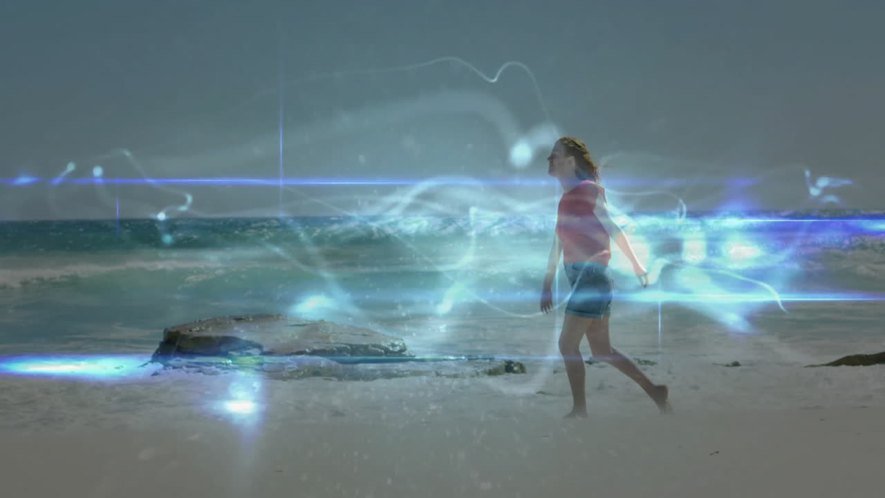 Woman walking on beach with glowing abstract light animation surrounding her