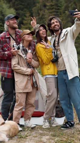 friends taking a selfie while camping in the mountains