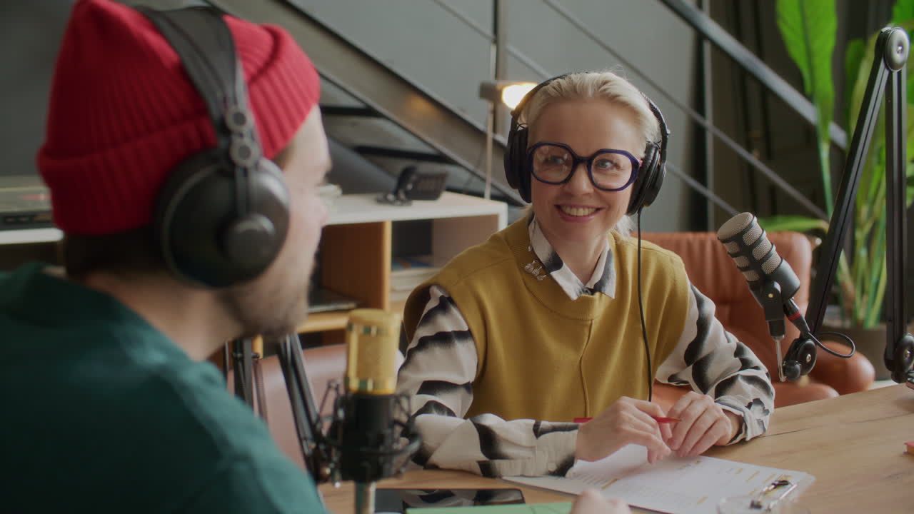 Smiling Woman Recording Audio Podcast with Colleagues in Studio