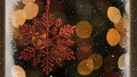 video composition with snow over room  with christmas decorations viewed through icy window