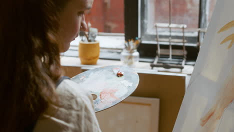 artist painting on a canvas