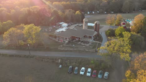 4k drone reveal of barn at sunset