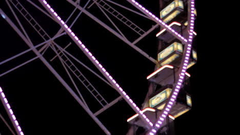 Close-up-shot-of-rotating-lighted-up-ferris-wheel-in-amusement-park