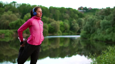 the girl warms up early in the morning before training preparing for a run in the sun