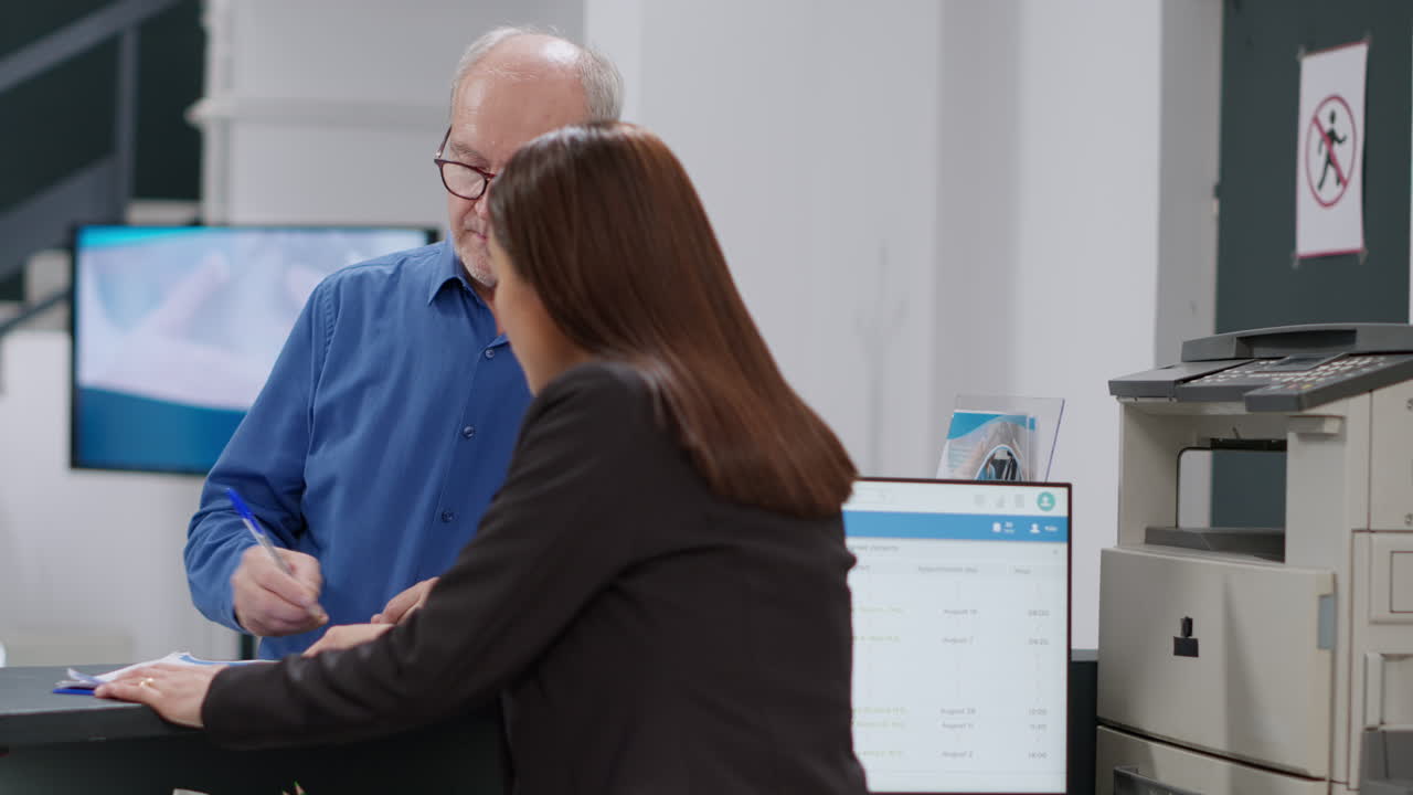 Patient signing paperwork at clinic reception
