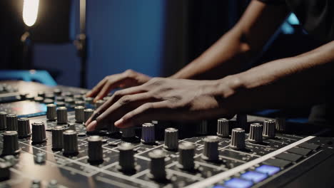 audio engineer working on a mixing console