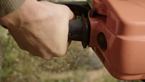 close-up of a person using a chainsaw to cut wood