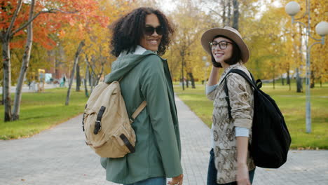 two friends walking in autumn park