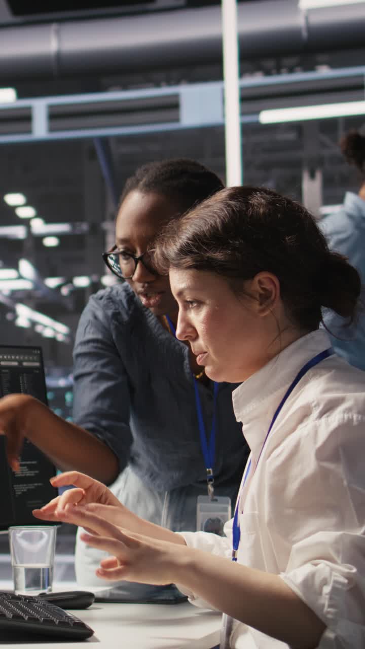 Vertical video Data center technicians adjusting blade server hardware powering AI