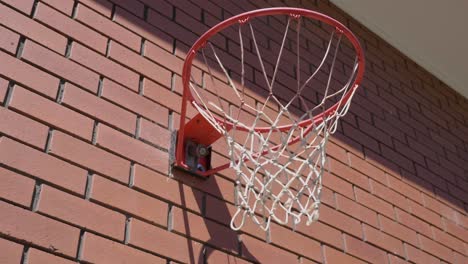 up close shot of basketball ring with ball circling metal ring and going into net to score a goal