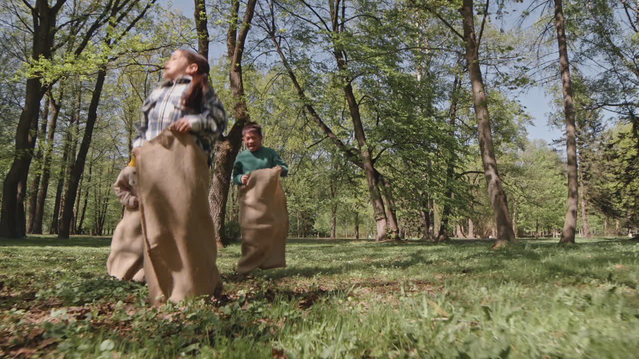 Children Enjoying a Sack Race in the Park