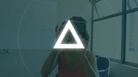 animation of circle and triangle, over woman wearing vr headset