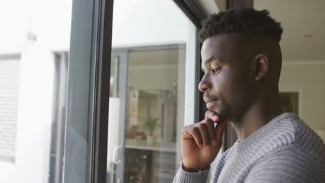 video of thoughtful african american man looking outside window