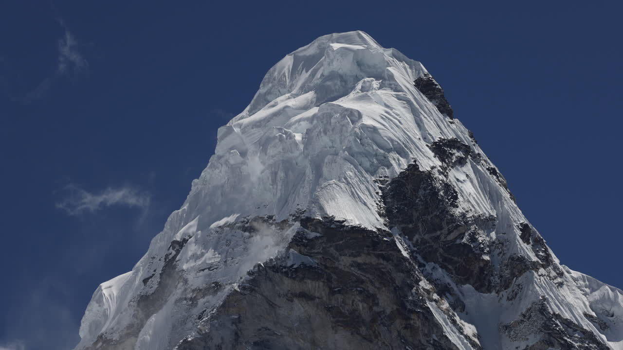 Timelapse of wind hitting mountain top with snow in Nepal.